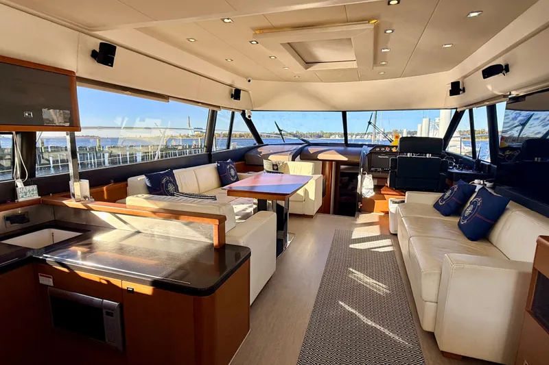 Slide: The Image of Luxurious interior of a 2014 Prestige 620 yacht with elegant seating and panoramic windows. - 18