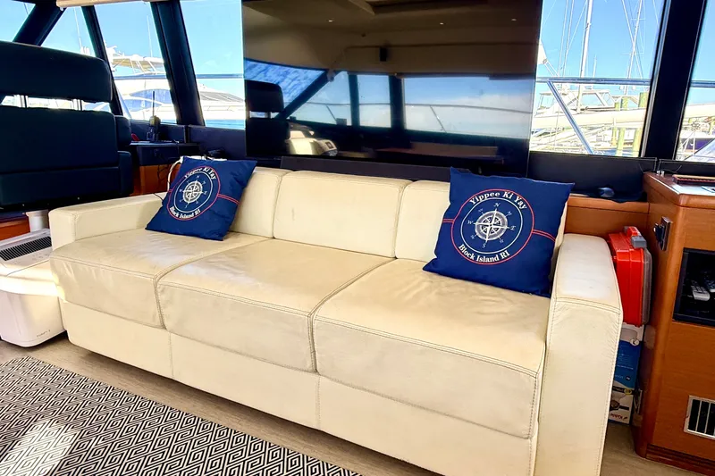 Slide: The Image of Luxurious interior of 2014 Prestige 620 yacht with cream sofa and nautical-themed cushions. - 26