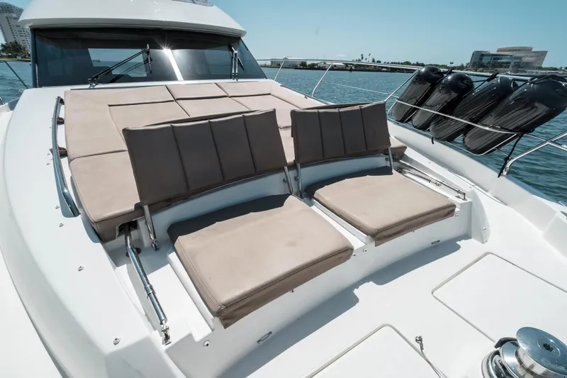 Slide: The Image of Luxurious sunbathing area on a 2014 Prestige 620 yacht, featuring comfortable seating and scenic views. - 16