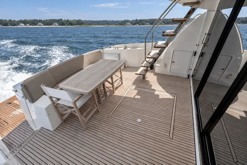 Slide: The Image of Prestige 620 yacht deck with seating and table, cruising on open water, 2014 model. - 7