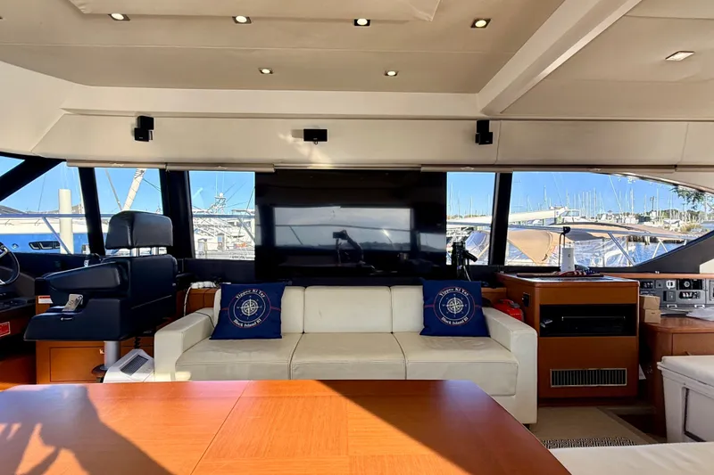 Slide: The Image of Luxurious interior of 2014 Prestige 620 yacht with plush seating and marina view. - 27