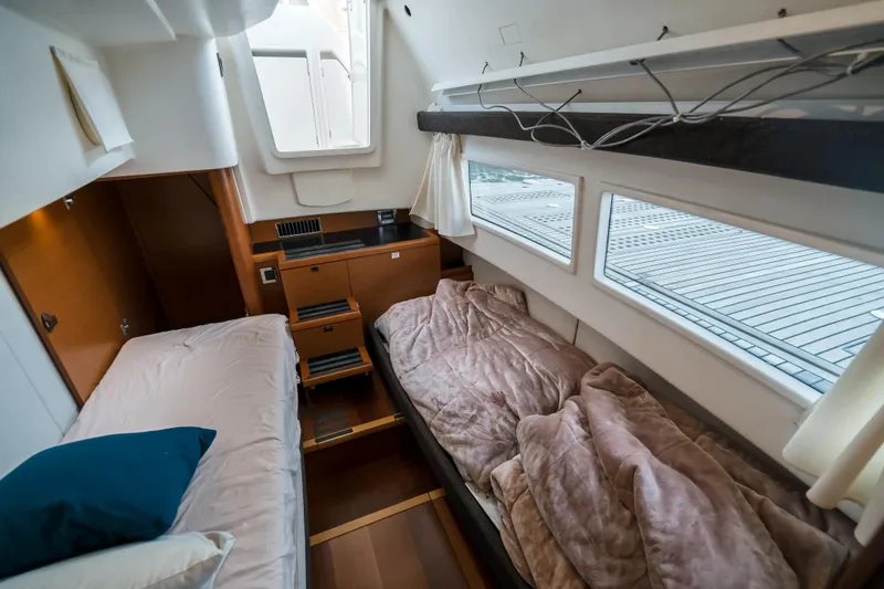 Slide: The Image of Interior cabin of a 2014 Prestige 620 yacht with twin beds and windows. - 50