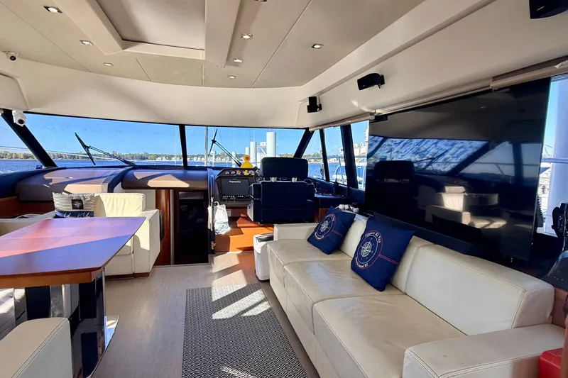 Slide: The Image of Luxurious interior of 2014 Prestige 620 yacht with modern seating and large windows. - 19
