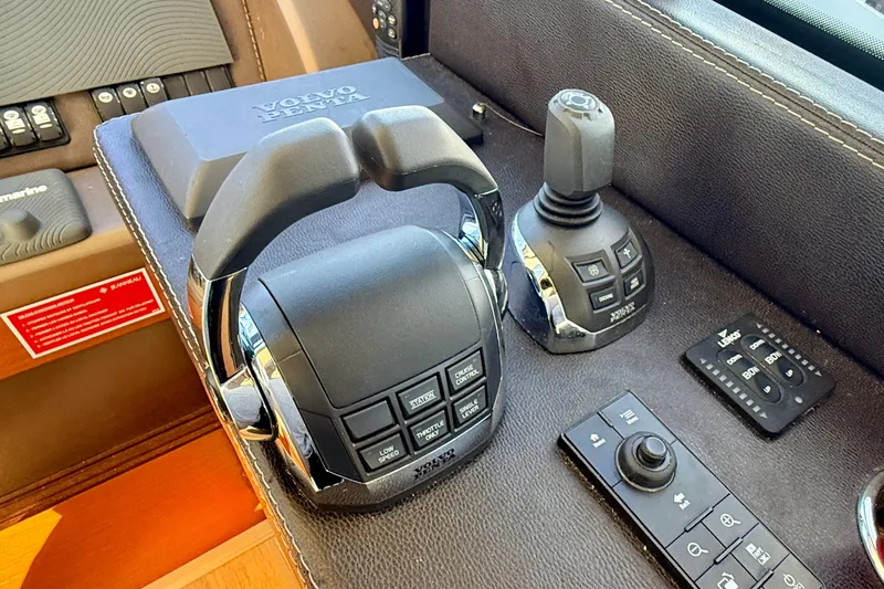 Slide: The Image of Control panel of a 2014 Prestige 620 yacht featuring Volvo Penta joystick and throttle. - 33