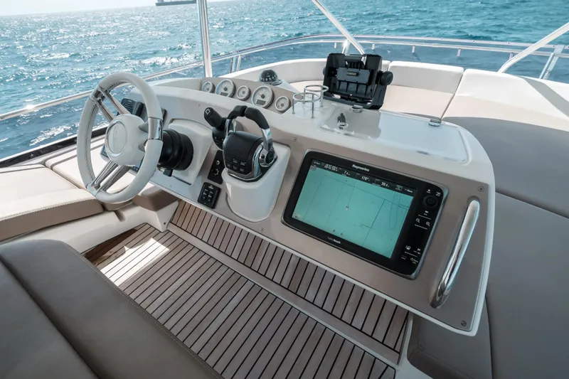 Slide: The Image of Cockpit of 2014 Prestige 620 yacht with navigation system and steering wheel. - 13