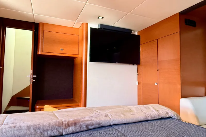 Slide: The Image of Luxurious interior of 2014 Prestige 620 yacht with wood paneling and mounted TV. - 38