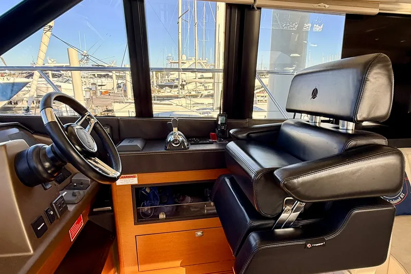 Slide: The Image of Luxurious helm station of a 2014 Prestige 620 yacht with leather seating and steering wheel. - 30