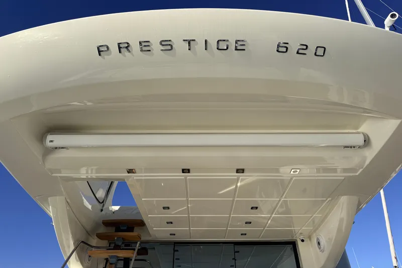 Slide: The Image of 2014 Prestige 620 yacht stern view with sleek design and modern lighting. - 53