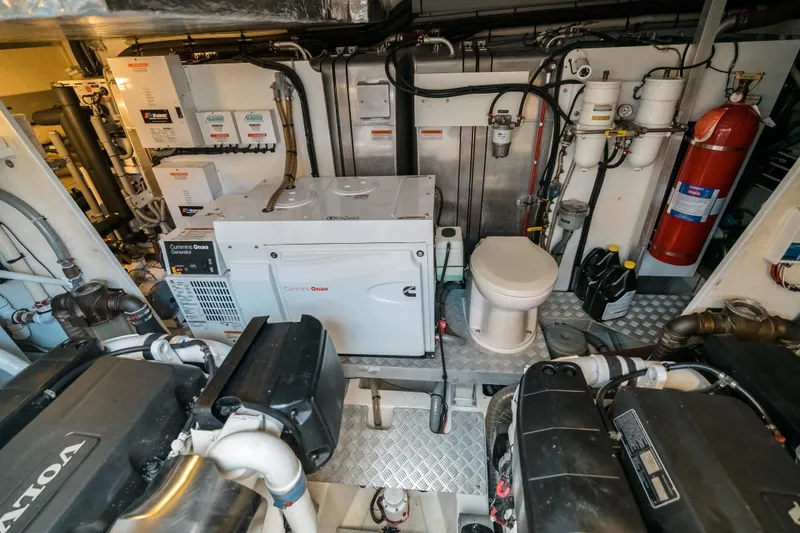 Slide: The Image of Engine room of a 2014 Prestige 620 yacht with Cummins Onan generator and equipment. - 57