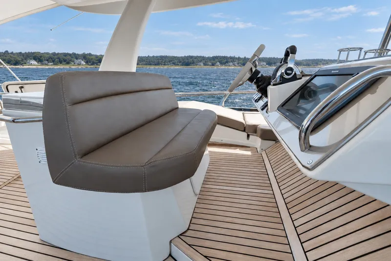 Slide: The Image of Luxurious 2014 Prestige 620 yacht helm with leather seating and wooden deck. - 14