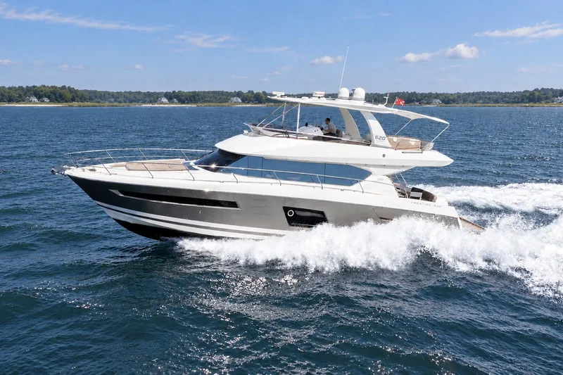 Slide: The Image of Luxurious 2014 Prestige 620 yacht cruising on open water under a clear blue sky. - 3
