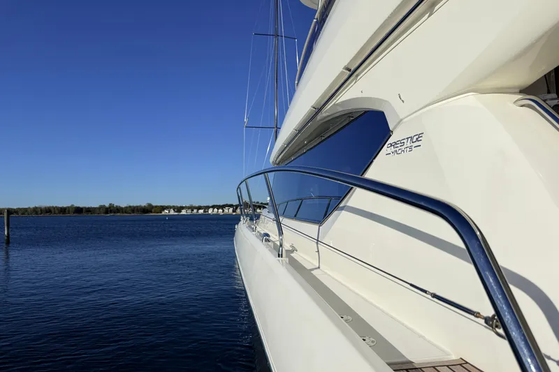 Slide: The Image of Luxury 2014 Prestige 620 yacht on calm blue water under clear sky. - 52