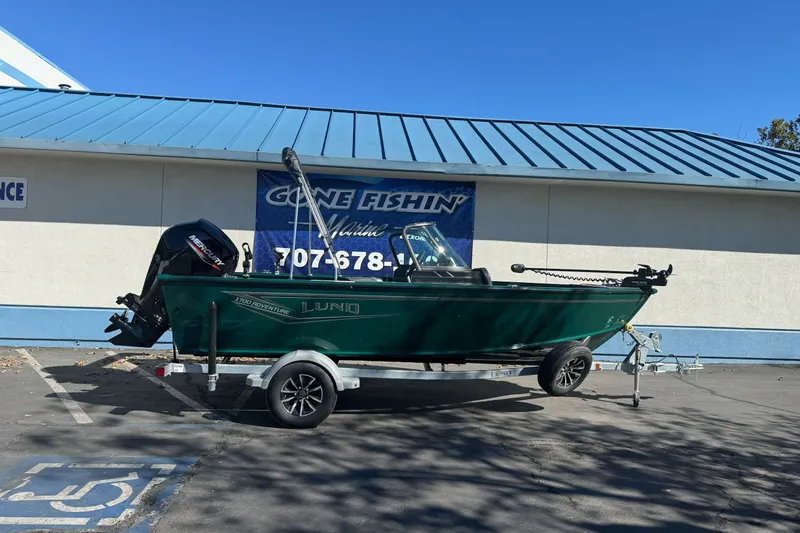 The Image of 2027 Lund 1700 Adventure Sport boat on trailer outside marine store. - 2
