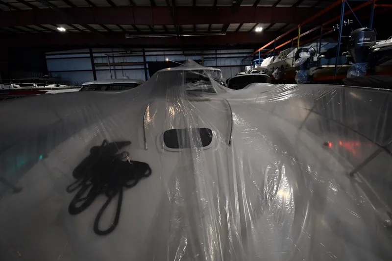 Slide: The Image of 2005 Sea Ray 420 Sundancer covered in plastic in a storage facility. - 4