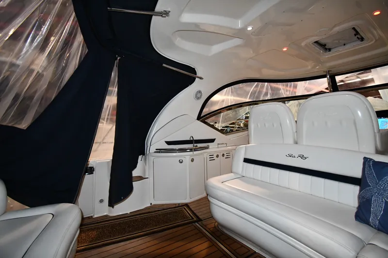 Slide: The Image of Interior of 2005 Sea Ray 420 Sundancer yacht with white seating and wood flooring. - 13