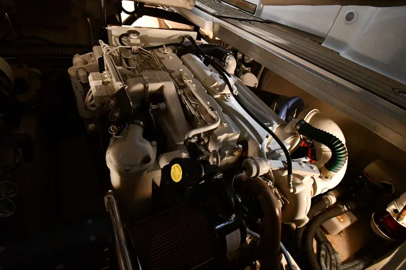 Slide: The Image of Engine compartment of a 2005 Sea Ray 420 Sundancer boat, showcasing mechanical components. - 47