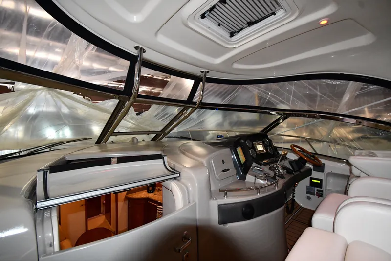 Slide: The Image of Interior view of 2005 Sea Ray 420 Sundancer yacht cockpit with modern controls and seating. - 7