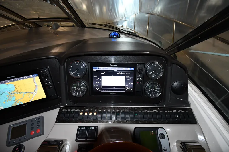 Slide: The Image of 2005 Sea Ray 420 Sundancer helm with navigation and control panels. - 10