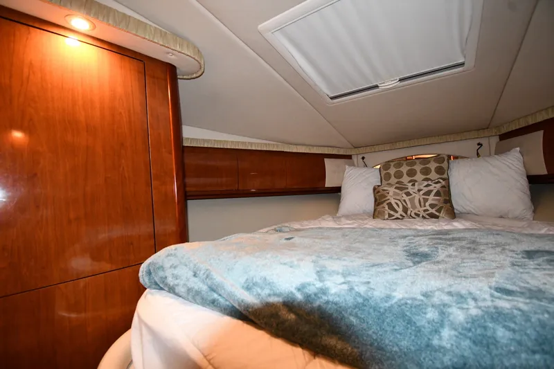 Slide: The Image of Luxurious cabin interior of 2005 Sea Ray 420 Sundancer yacht with cozy bedding. - 22