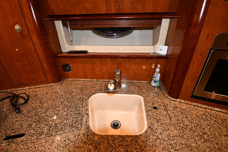 Slide: The Image of Luxurious kitchen sink area in 2005 Sea Ray 420 Sundancer yacht. - 32