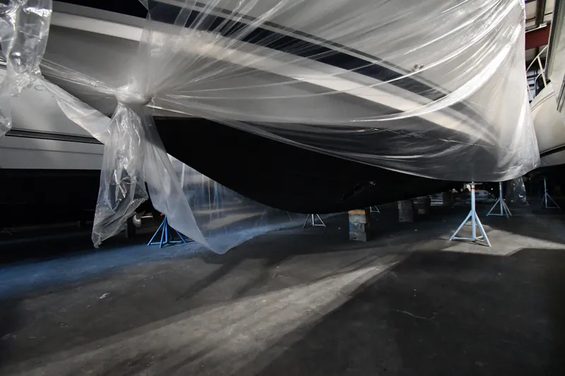 Slide: The Image of 2005 Sea Ray 420 Sundancer yacht covered in protective plastic wrap in storage. - 50