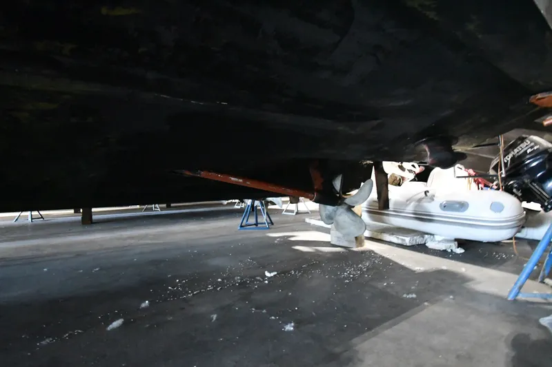 Slide: The Image of Underneath view of a 2005 Sea Ray 420 Sundancer on stands in a storage area. - 52