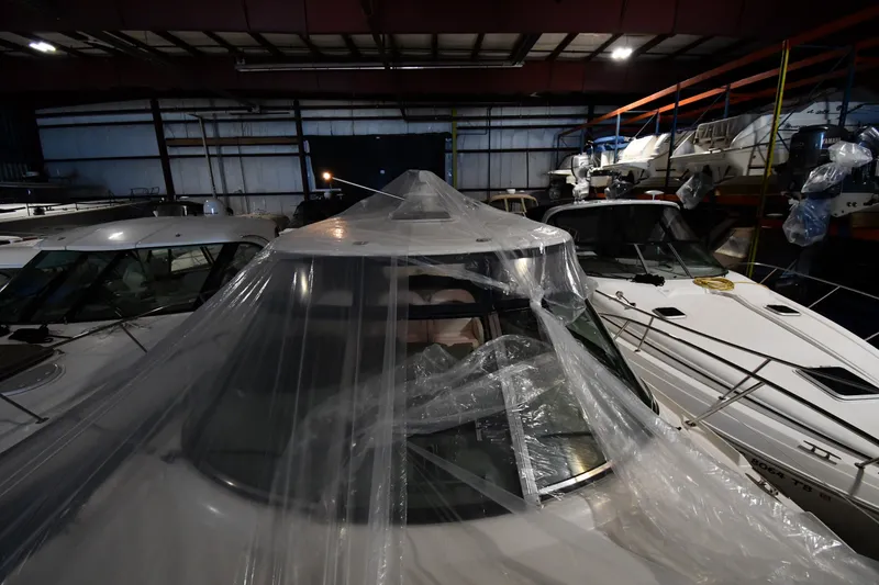 Slide: The Image of 2005 Sea Ray 420 Sundancer yacht covered in plastic, stored indoors. - 5