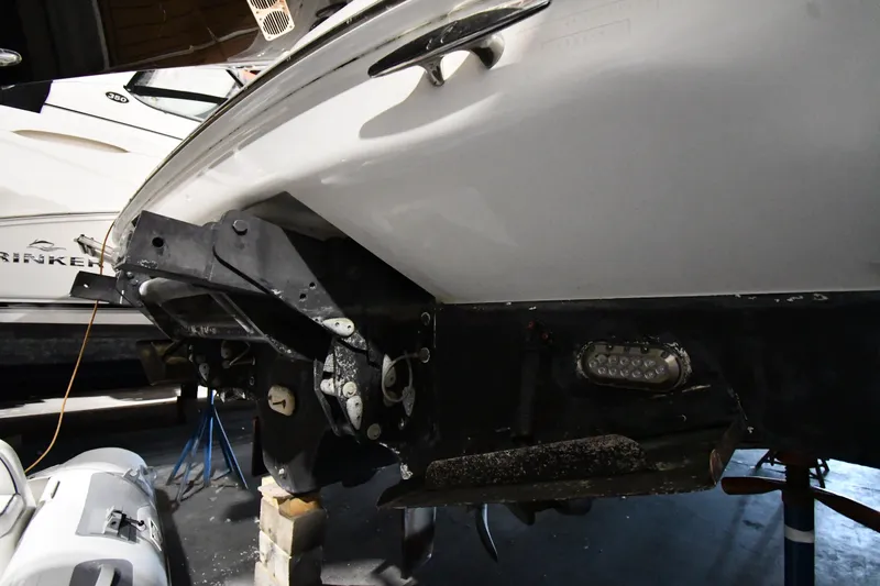 Slide: The Image of 2005 Sea Ray 420 Sundancer boat hull and stern drive in a workshop setting. - 56