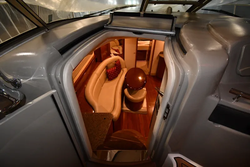 Slide: The Image of Interior view of 2005 Sea Ray 420 Sundancer yacht, featuring elegant seating and wood finishes. - 18