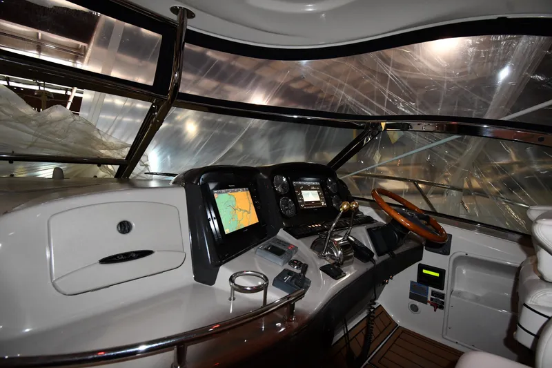 Slide: The Image of Helm of 2005 Sea Ray 420 Sundancer with navigation equipment and wooden steering wheel. - 8