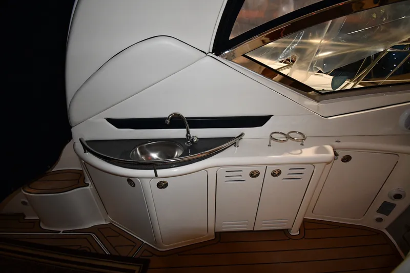 Slide: The Image of 2005 Sea Ray 420 Sundancer yacht interior with sink and storage cabinets. - 16