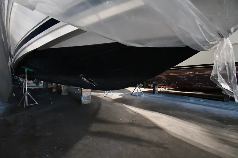 Slide: The Image of 2005 Sea Ray 420 Sundancer yacht in dry dock, covered and supported by stands. - 51