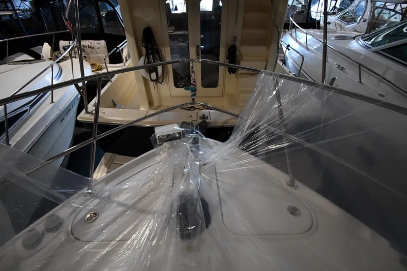 Slide: The Image of 2005 Sea Ray 420 Sundancer yacht in storage, covered with protective plastic wrap. - 3