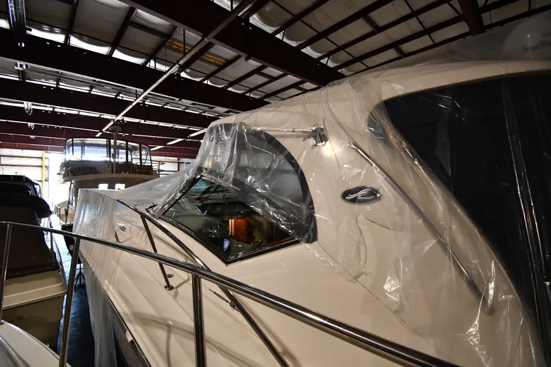 Slide: The Image of 2005 Sea Ray 420 Sundancer yacht stored indoors, covered with protective plastic. - 1