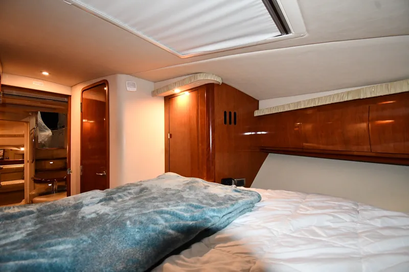 Slide: The Image of Luxurious cabin interior of 2005 Sea Ray 420 Sundancer yacht with cozy bedding. - 23