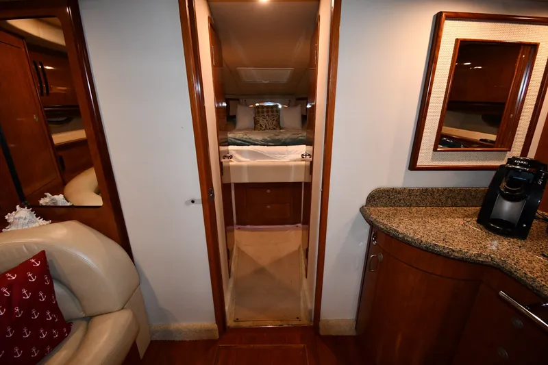 Slide: The Image of Interior of 2005 Sea Ray 420 Sundancer yacht with cozy cabin and kitchenette. - 19