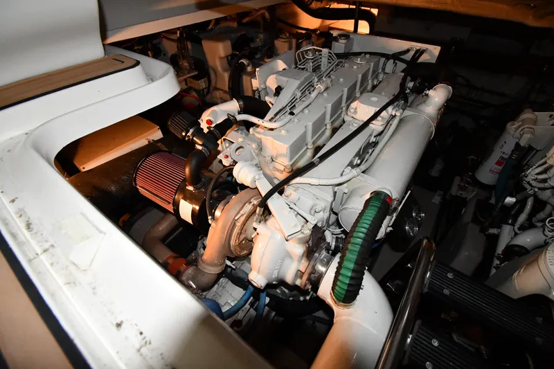 Slide: The Image of Engine compartment of a 2005 Sea Ray 420 Sundancer boat, showcasing mechanical components. - 48