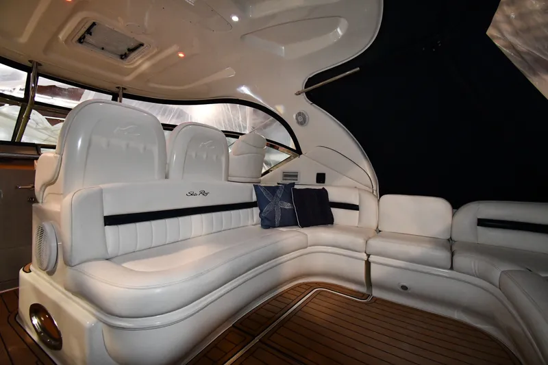 Slide: The Image of Luxurious interior of 2005 Sea Ray 420 Sundancer with white leather seating and wood flooring. - 12