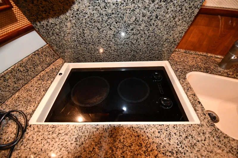 Slide: The Image of Granite countertop with built-in electric stove on 2005 Sea Ray 420 Sundancer yacht. - 34