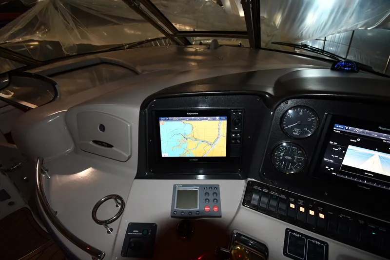 Slide: The Image of 2005 Sea Ray 420 Sundancer helm with navigation screens and gauges. - 9