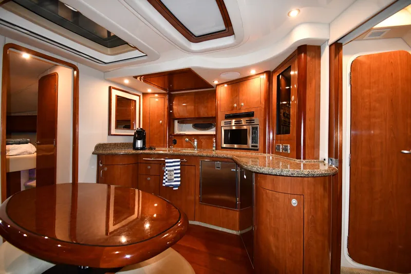 Slide: The Image of Luxurious 2005 Sea Ray 420 Sundancer yacht interior with modern kitchen and dining area. - 28