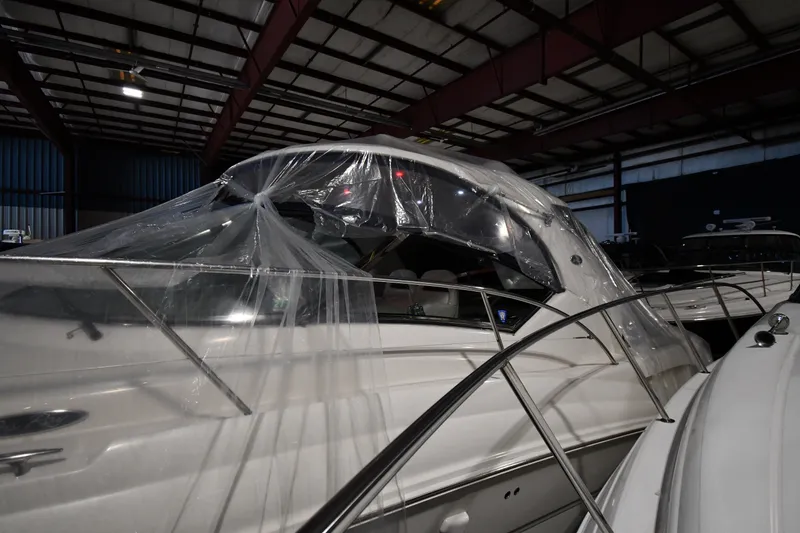 Slide: The Image of 2005 Sea Ray 420 Sundancer yacht covered in plastic, stored indoors. - 2