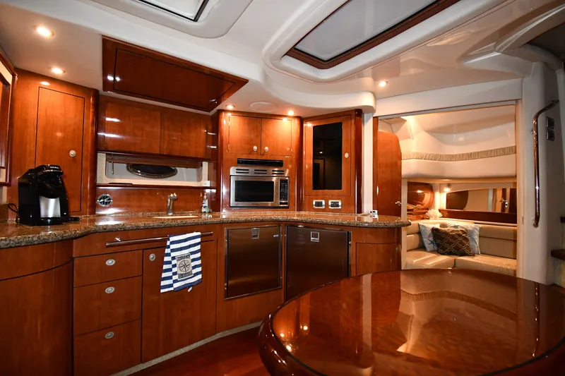 Slide: The Image of Luxurious interior of 2005 Sea Ray 420 Sundancer yacht with modern kitchen and cozy seating area. - 31