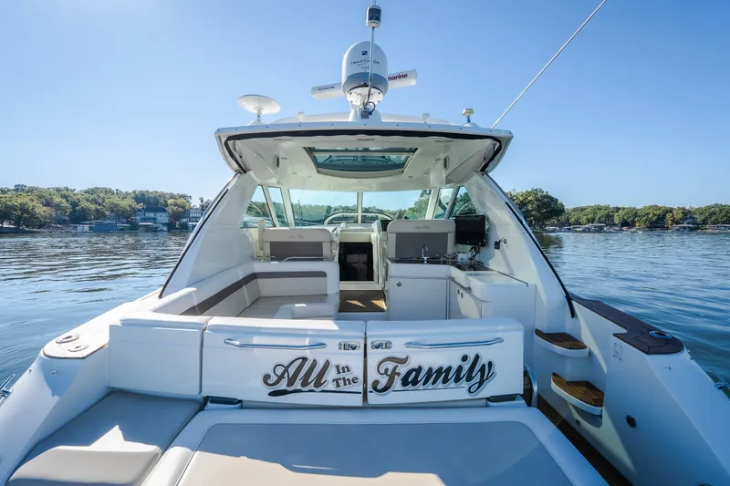 Slide: The Image of 2012 Sea Ray 450 Sundancer yacht on a serene lake, featuring "All in the Family" text. - 15