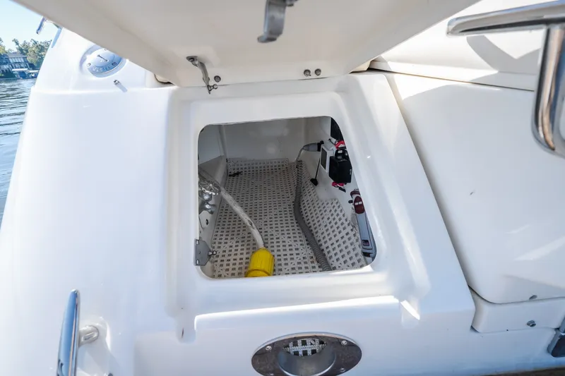 Slide: The Image of Open storage compartment on a 2012 Sea Ray 450 Sundancer boat. - 56