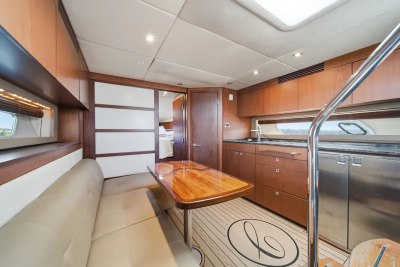 Slide: The Image of Luxurious interior of 2012 Sea Ray 450 Sundancer yacht with modern kitchen and seating area. - 37