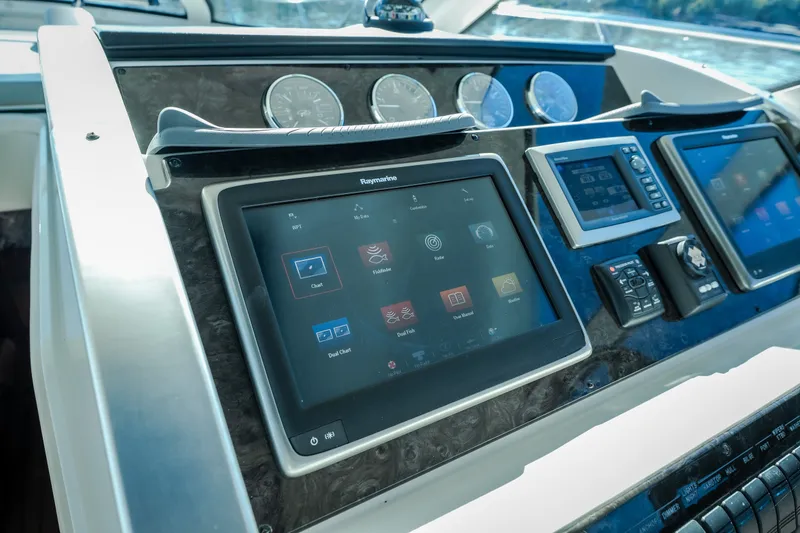 Slide: The Image of Control panel of a 2012 Sea Ray 450 Sundancer yacht with navigation screens. - 28