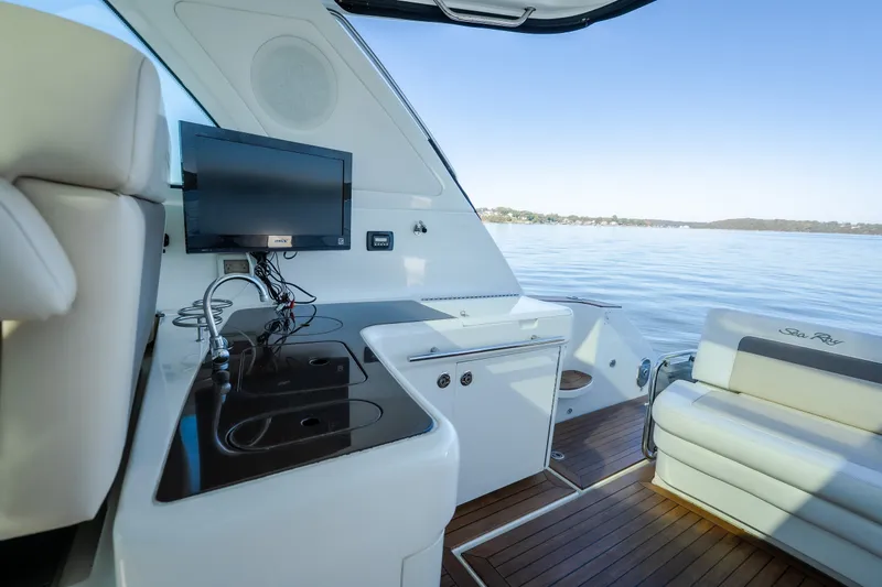 Slide: The Image of Interior view of 2012 Sea Ray 450 Sundancer yacht with seating and entertainment area. - 55