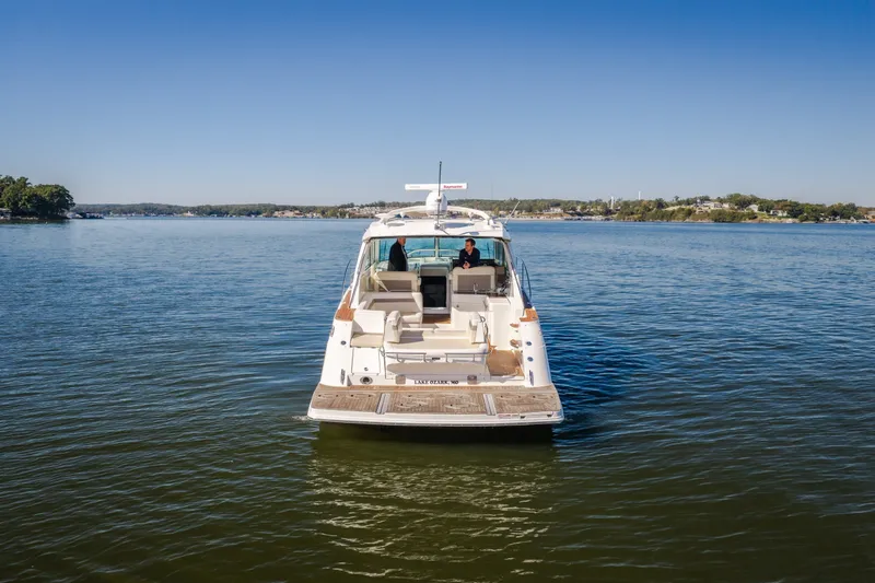 Slide: The Image of 2012 Sea Ray 450 Sundancer yacht on calm water, rear view. - 3