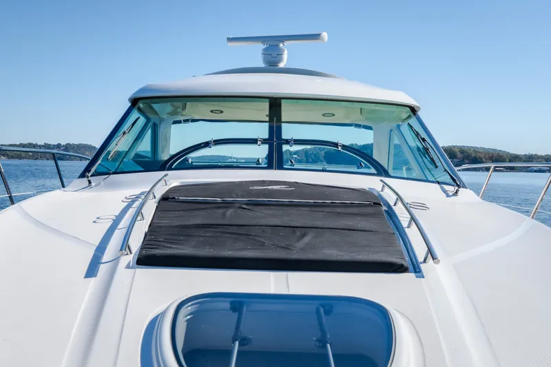 Slide: The Image of 2012 Sea Ray 450 Sundancer yacht on calm water, showcasing sleek design and spacious deck. - 50